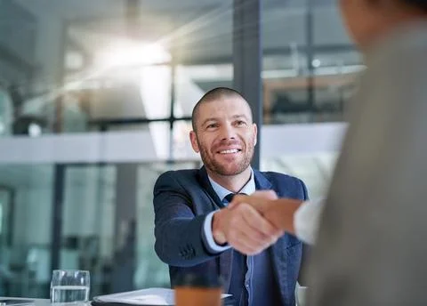 Forging profitable connections. two businessmen shaking hands in a modern office Stock Photos