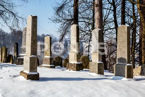 Forgotten and unkempt jewish cemetery with the strangers Stock Photos
