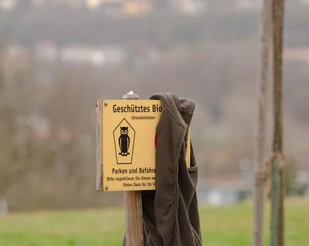 Forgotten Fleece Jacket Draped Over a German Nature Reserve Sign Stock Photos