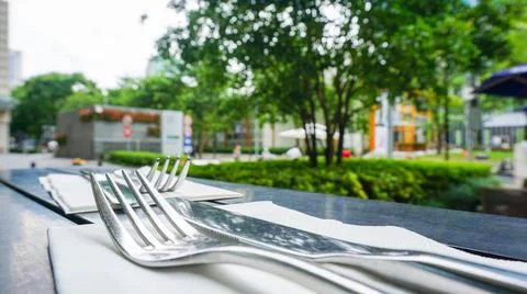 Fork and knife close up at the restaurant terrace after covid reopen, China Stock Photos