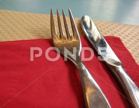 Fork and knife place setting in bistro Stock Photos