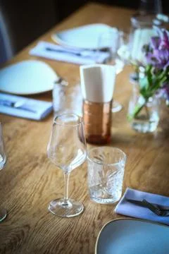 Fork and knife on a table, near a plate Stock Photos