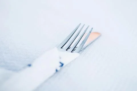 A fork and a knive at a restaurant table Stock Photos