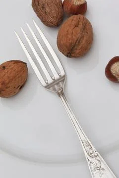 Fork and nuts Stock Photos