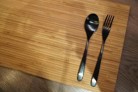 Fork and spoon arrangement on empty table Stock Photos