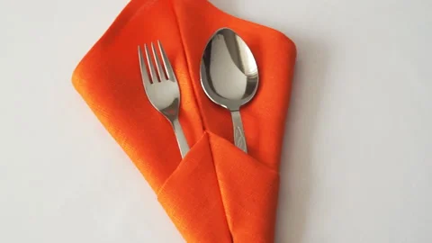 Fork and spoon. Fork and spoon in textile napkin on table Stock-Footage 93876949