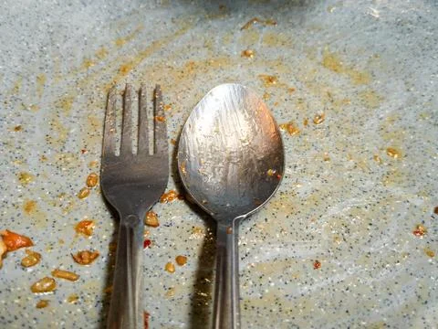A Fork And Spoon On A Gray Plate Stock Photos