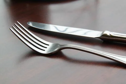 Fork and spoon isolated on dining table Stock Photos