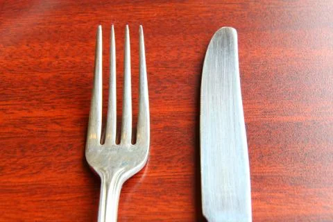 Fork and spoon isolated on dining table Stock Photos