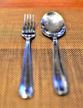 A fork and a spoon silverware arranged neatly Stock Photos