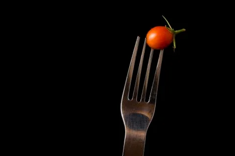 Fork and tomato in close up Stock Photos