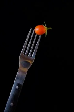 Fork and tomato illuminated with studio lights Stock Photos