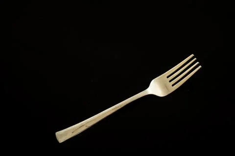 Fork on a black table polished by me Stock Photos