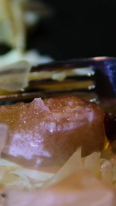 Fork breaking caramelized pear with crispy puff pastry and creamy syrup on black Stock Footage 318730880