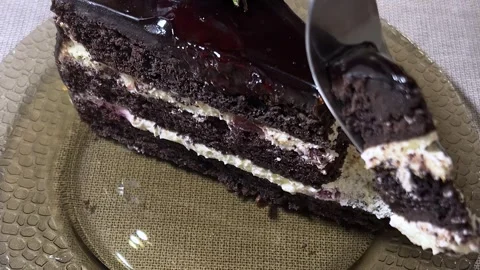 Fork breaks off juicy red fresh piece of chocolate brown cake Stock Footage 310902186