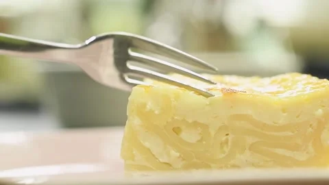 Fork breaks off a piece baked macaroni pudding. Stock Footage 165614223