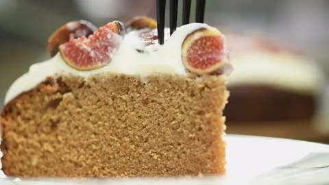 Fork breaks off a piece of honey and coffee cake. 스톡 동영상 169799652