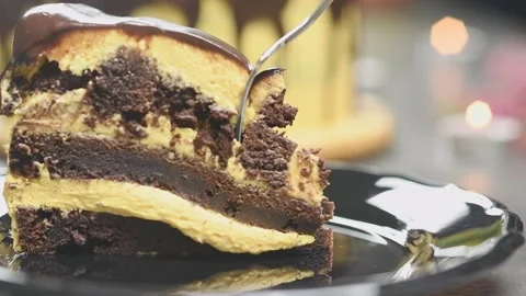 Fork breaks off a piece of pumpkin chocolate cake. Stock Footage 159908260