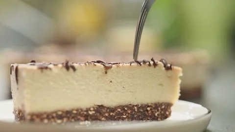 The fork breaks off a piece of raw no-bake chocolate cake. Stock Footage 165467283