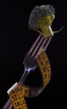 Fork with Broccoli isolated on the black Stock Photos