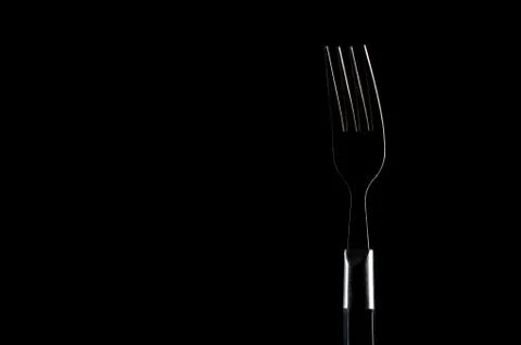 Fork contours over the black background Stock Photos