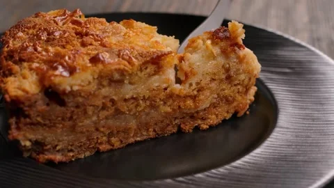 Fork cuts off a piece of delicate dry dough pie on a dessert plate Stock-Footage 334338557
