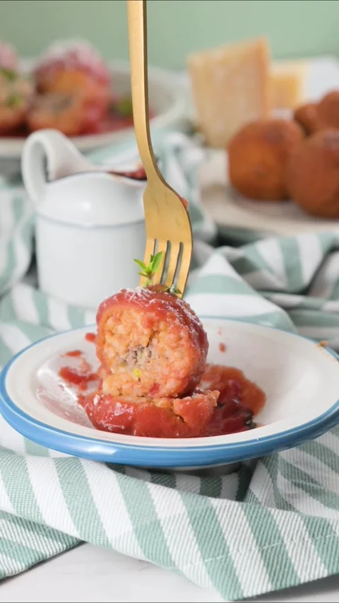 Fork cutting through Sicilian arancini with tomato sauce. Juicy texture, rich Video stock 311817646
