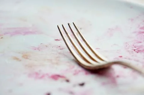 A fork on a dirty plate Stock Photos