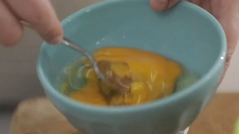 Fork egg mixing in slow motion Stock Footage 76373877