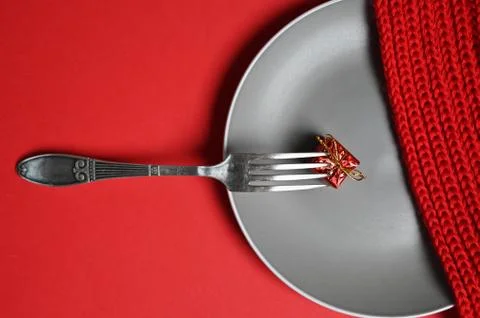 Fork with a gift on a plate Fotos Stock