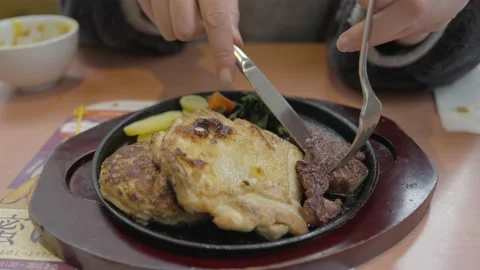 Fork grabs steak from platter Stock Footage 232176085
