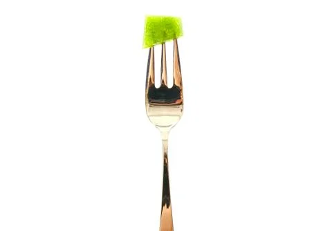 Fork with a green pepper slice isolated on white background. Stock Photos