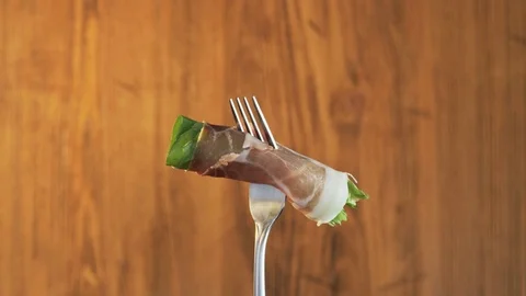 Fork With Ham and Lettuce on Wooden Background Stock Footage 70534434
