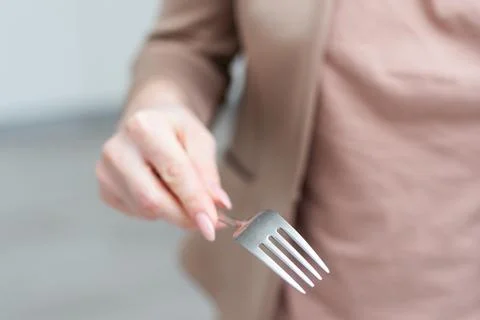 Fork in a hand on a white background isolation Stock Photos