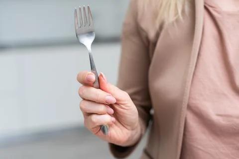 Fork in a hand on a white background isolation Stock Photos