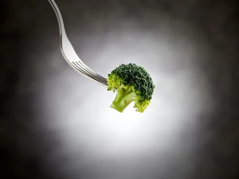 Fork is holding broccoli Stock Photos