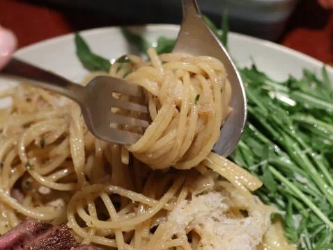 A fork is holding a piece of pasta Stock Photos
