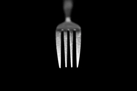 Fork isolated on a black background Photos