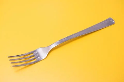 Fork isolated on yellow background Stock Photos