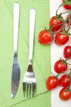 Fork knife and tomatoes Stock Photos