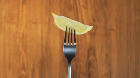Fork With Lemon on Wooden Background Stock Footage 70534503