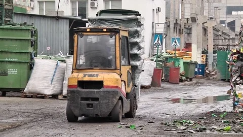 Fork lift trucks plastic garbage containers Stock Footage 84282642