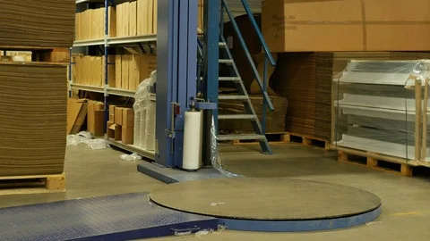 Fork lifted Pallet transported to stretch wrapping machine Stock Footage 77616307