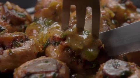 Fork lifting a slice of a juicy grilled champignon mushroom Stock Footage 312471679