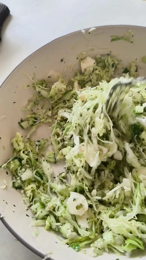 Fork mixing fresh cabbage salad in ceramic bowl. 스톡 동영상 347457617