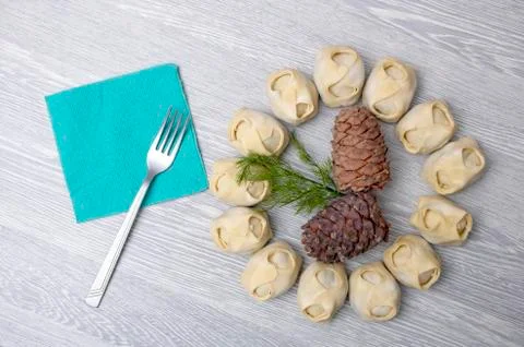 Fork, napkin and pine nuts with manti around, asian food Stock Photos