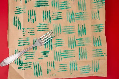Fork in paint, decorative stamps, sheets of paper. DIY crafting project for.. Foto stock