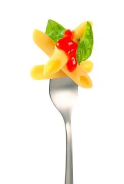 Fork with pasta and cherry tomato garnish Stock Photos