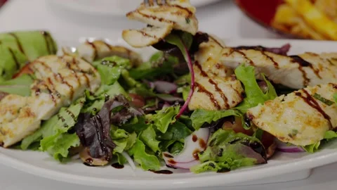 Fork Picking Up Grilled Chicken from Fresh Salad Stock-Footage 324692904