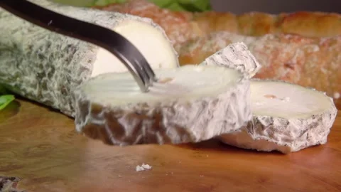 Fork picks up a piece Natural goat cheese with gray mold Stock Footage 302108028